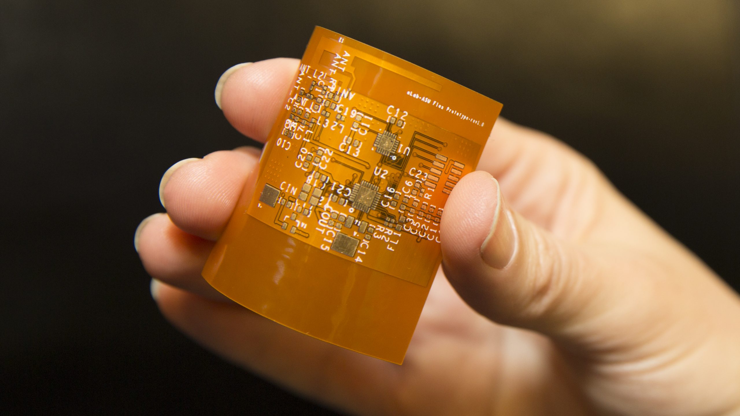 A hand holding an electronic board
