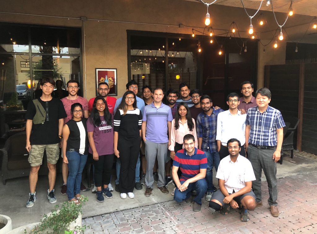 Group photo of people standing together at restaurant